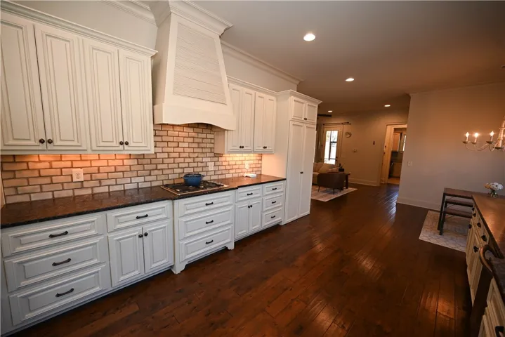 Under cabinet lighting, natural stone counter tops, and gas cook top.