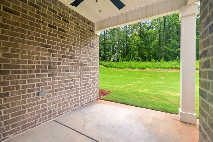 A spacious covered patio offers peaceful views of the surrounding natural landscape.