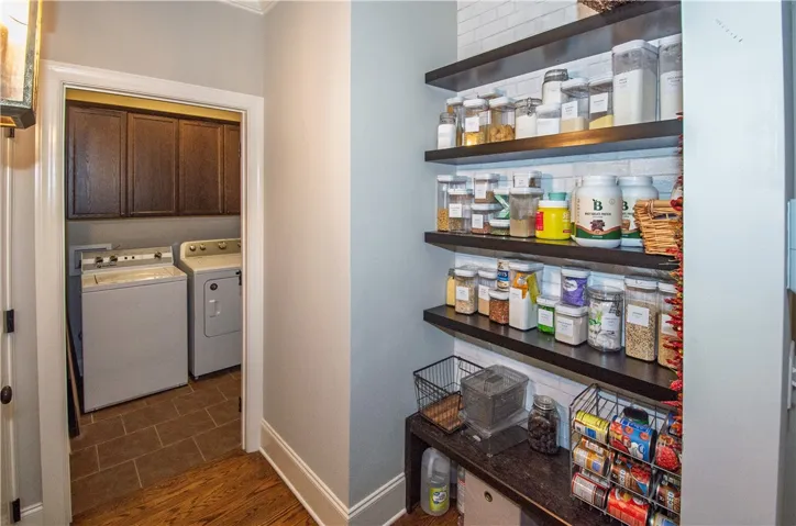 Custom designed pantry is easily accessible to the kitchen
