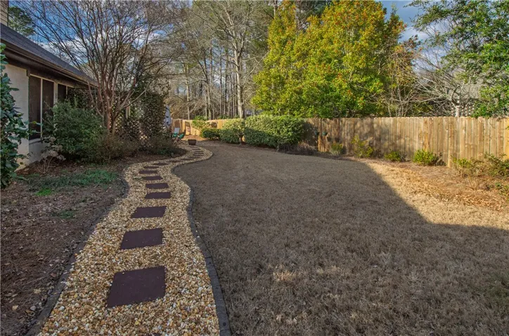 newly landscaped pebble walkway and new privacy fence