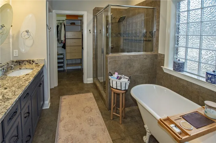 primary bath with clawfoot soaking tub and walk in closet