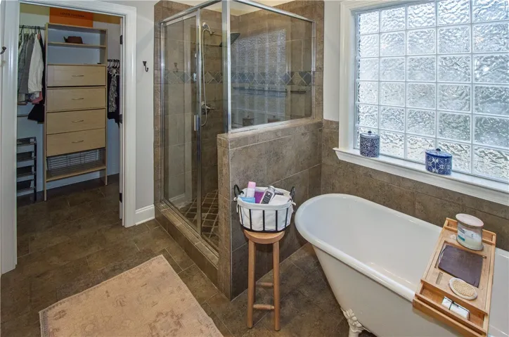 custom cabinetry in walk in closet of primary bedroom