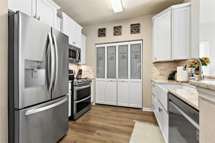 Beautifully updated kitchen with farmhouse sink, all new finishes and appliances in summer of 2022.