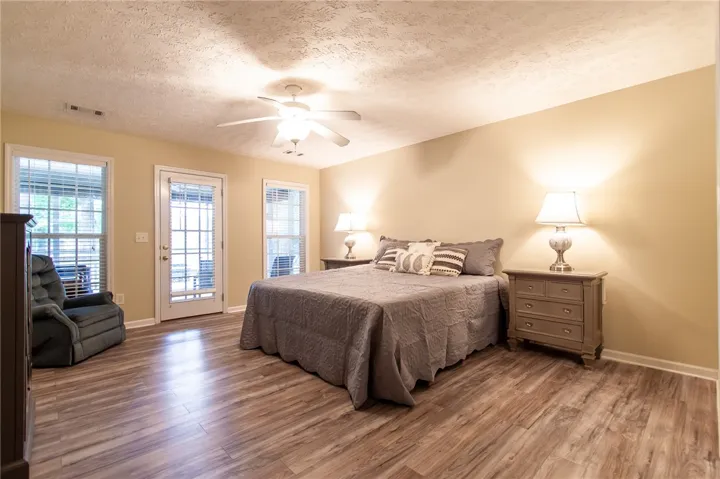 Primary Bedroom with lake view and access to screened porch