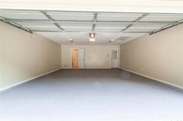 Double Garage (heated & cooled)with  1/2 bath. Attic with floored storage.