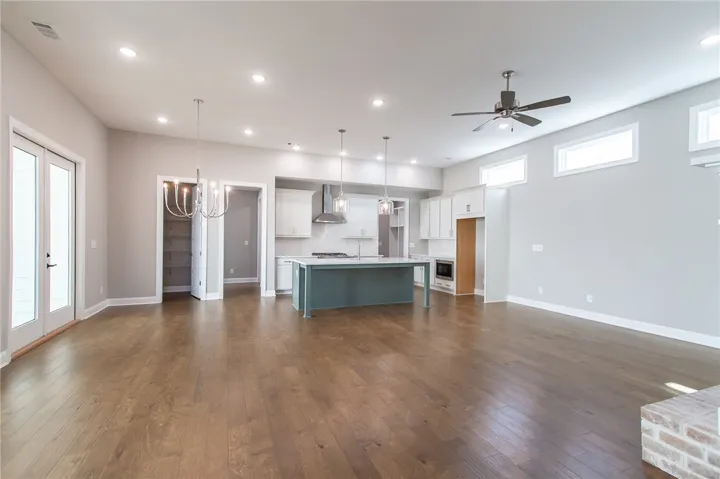 This expansive open concept space features a gourmet kitchen and rich hardwood flooring throughout.