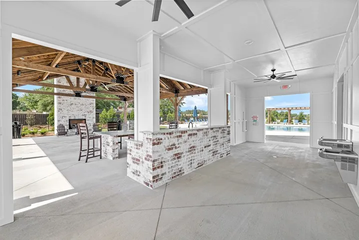 This inviting covered patio features a beautiful fireplace, perfect for gatherings and relaxation.
