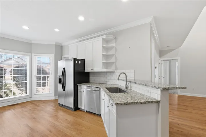 Bar-height kitchen counter overhang for seating opens to the living space.
