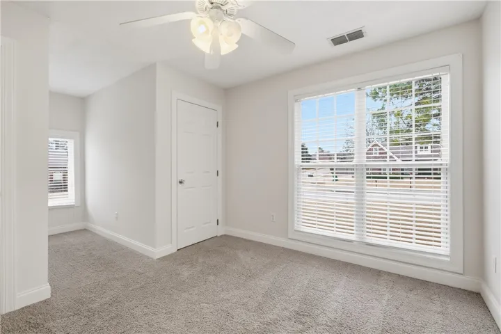 Second-floor bedroom with two closets flanking the window nook, plus an additional oversized storage closet.