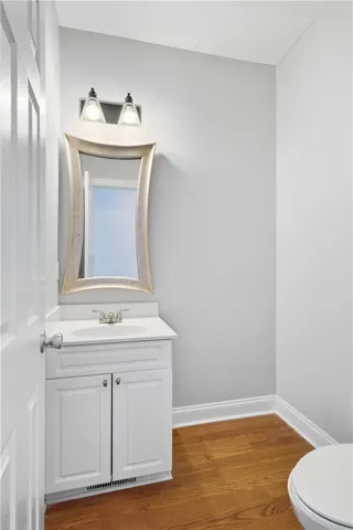 A conveniently located powder room serves the common spaces of the home.