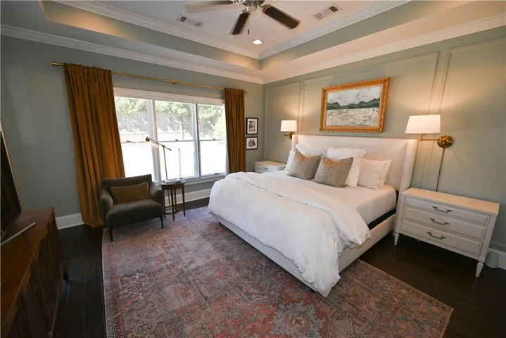 Primary bedroom with stunning accent wall, trey ceilings & sound proof windows.