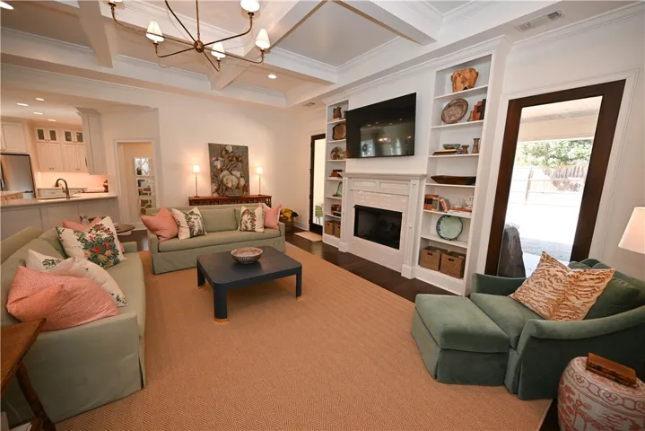 Cozy & elegant great room with coffered ceilings, built-ins & gas log fireplace.
