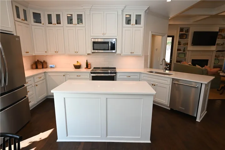 Kitchen features under cabinet lighting & a tiled backsplash