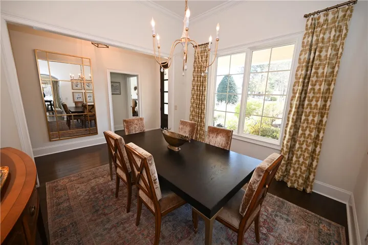 Stunning dining room with new lighting and large windows.