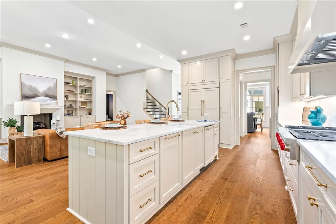 Culinary excellence awaits in this well-appointed kitchen, featuring a spacious island and gleaming hardwood floors and top of the line appliances.