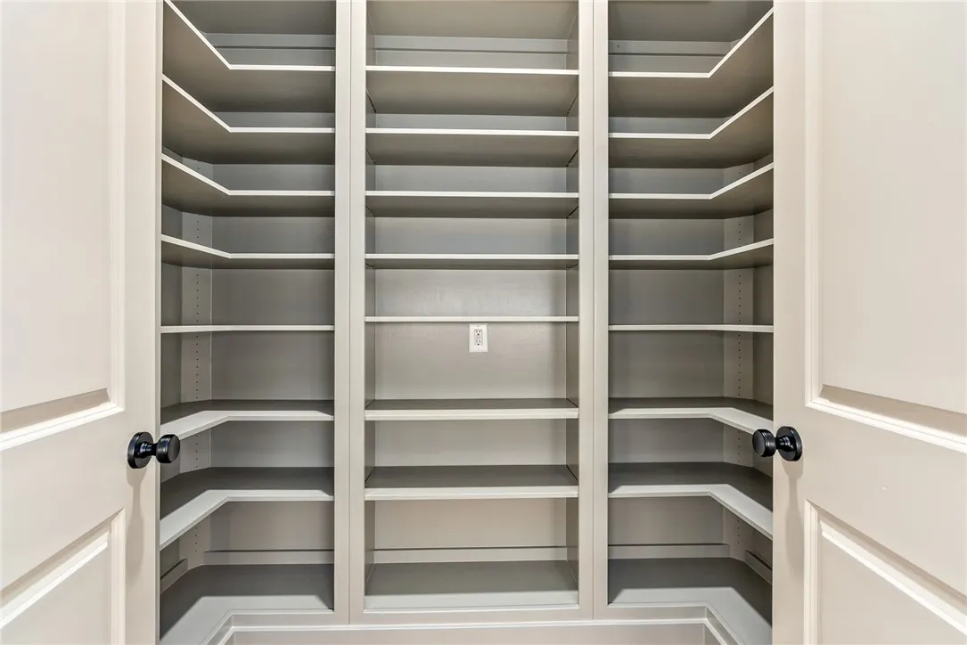 Ample built-in adjustable shelving provides generous storage space, perfect for organization.