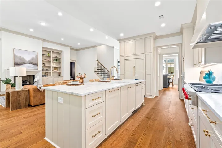 Culinary excellence awaits in this well-appointed kitchen, featuring a spacious island and gleaming hardwood floors and top of the line appliances.