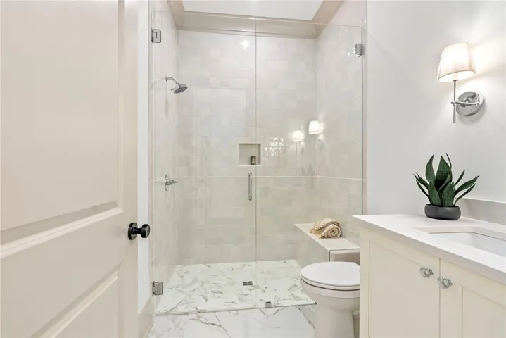 A well-appointed bath features a spacious walk-in shower and ample vanity space.