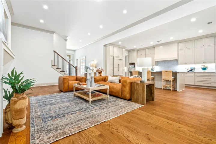 An inviting open-concept living area boasts gleaming hardwood floors and a seamlessly integrated kitchen.