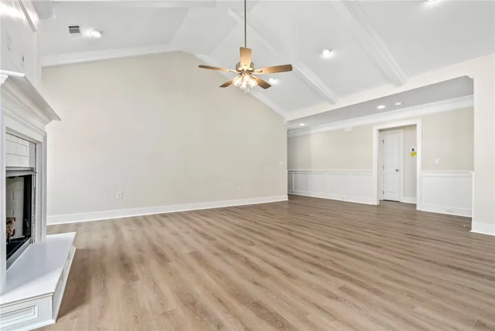 A spacious living area offers impressive vaulted ceilings and refined wainscoting.