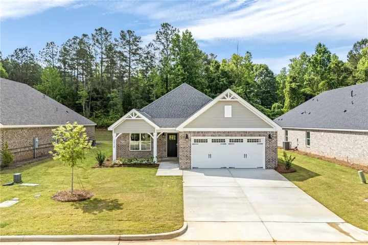 A classic brick facade and tidy lawn welcome you home to this inviting suburban retreat.