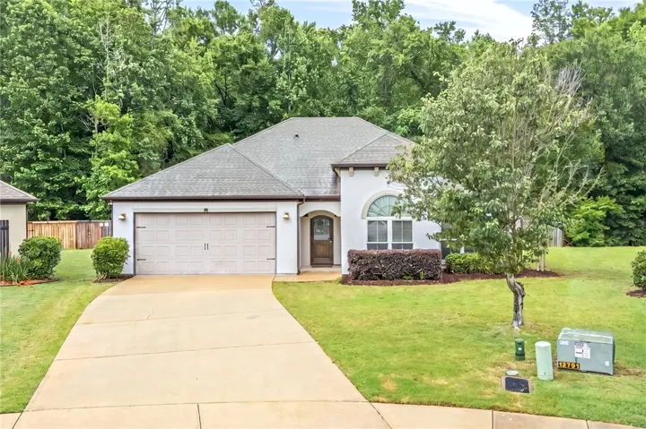A well-maintained facade with mature landscaping provides a welcoming entrance.