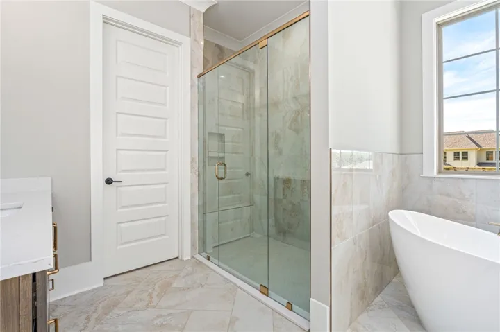 Modern bathing sanctuary featuring a glass-enclosed shower and a sleek, free-standing tub.