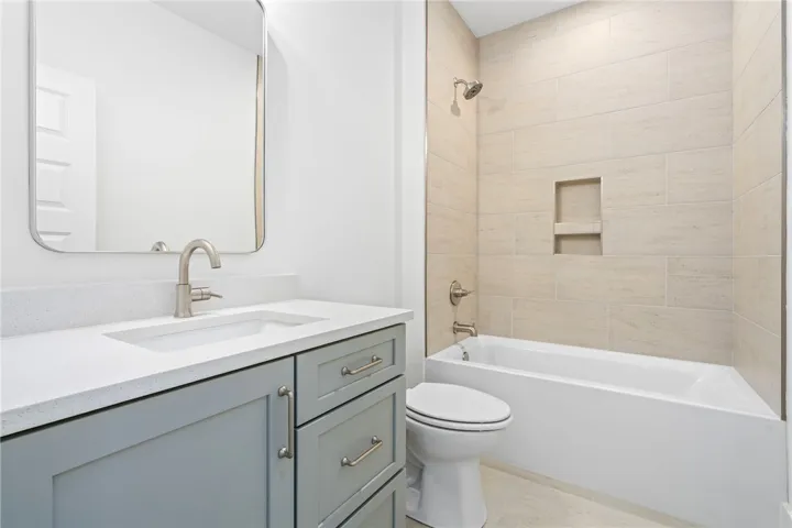 A well-appointed bath boasts sleek cabinetry and a convenient tub/shower combination.