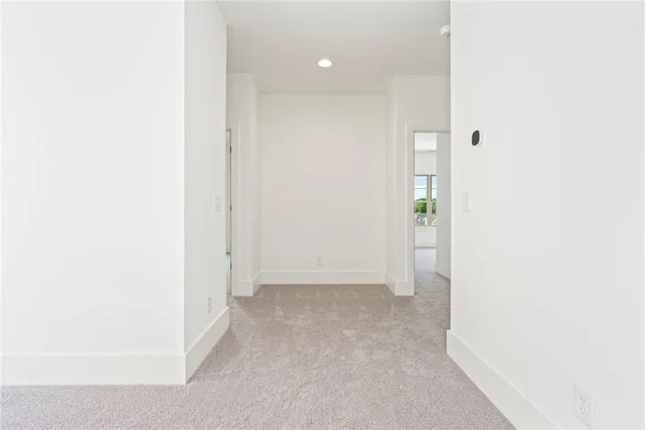 A well-lit corridor provides a clear pathway through this contemporary residence.