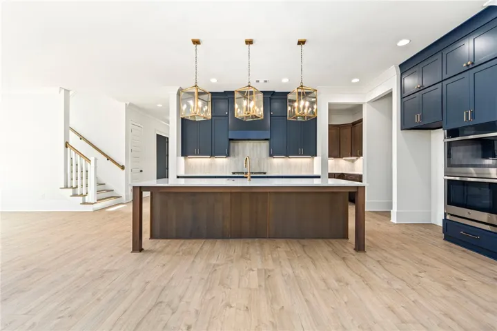 Culinary excellence awaits in this kitchen featuring a spacious island and top-tier appliances.