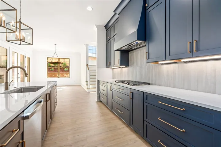 A well-appointed kitchen showcasing an island with a sink and a contemporary range.