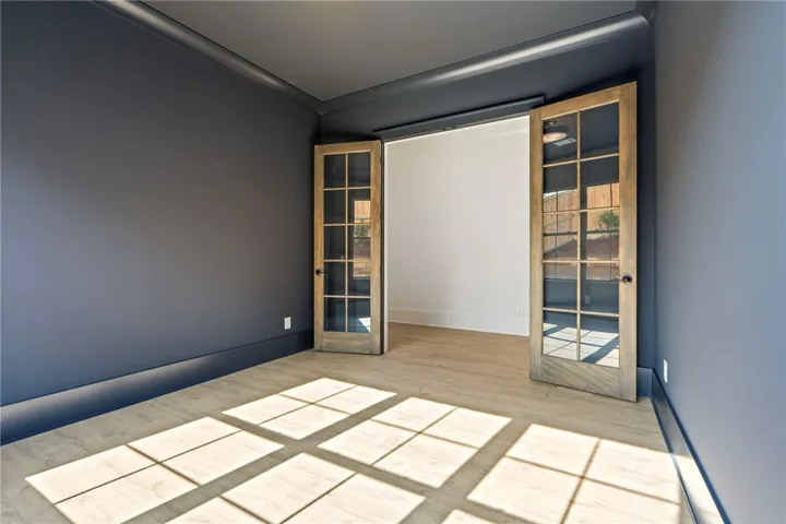 Sun-drenched interiors await in this versatile space, perfect for an office or den.