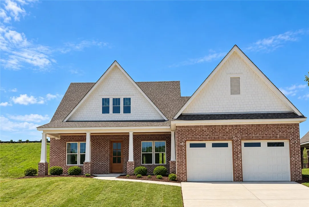 his charming residence features a classic facade with gabled roofs and an inviting entrance.