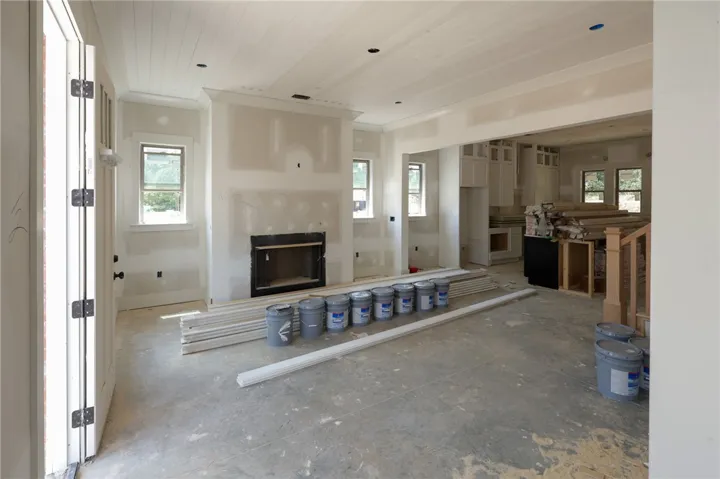 An inviting open-concept space featuring a fireplace, awaiting your personal touch.