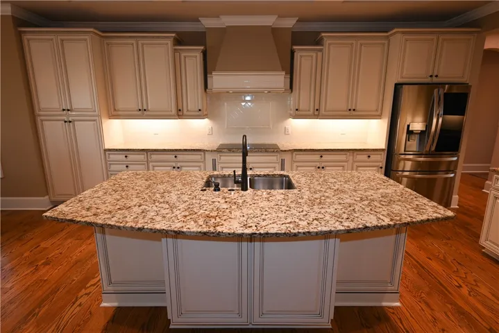 Huge center island, custom cabinetry with underlighting.