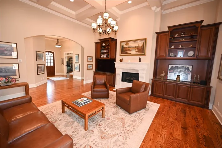 Beautiful chandelier and built-ins framing the gas fireplace.