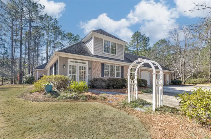 Side view of the home with side entrance into sunroom from driveway