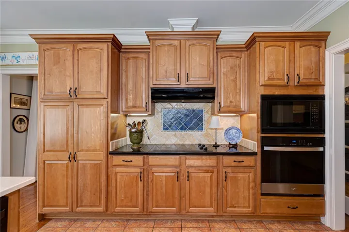 Cabinets to the left of oven top are for pantry storage