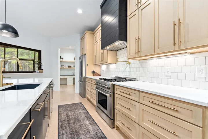 Extended kitchen cabinets with oversized 36” gas range