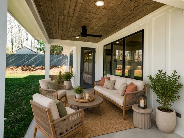This inviting patio features a natural wood ceiling, creating a warm and welcoming outdoor living space.