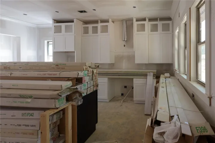 This kitchen in progress showcases new cabinetry and ample natural light, ready for your personalized touch.
