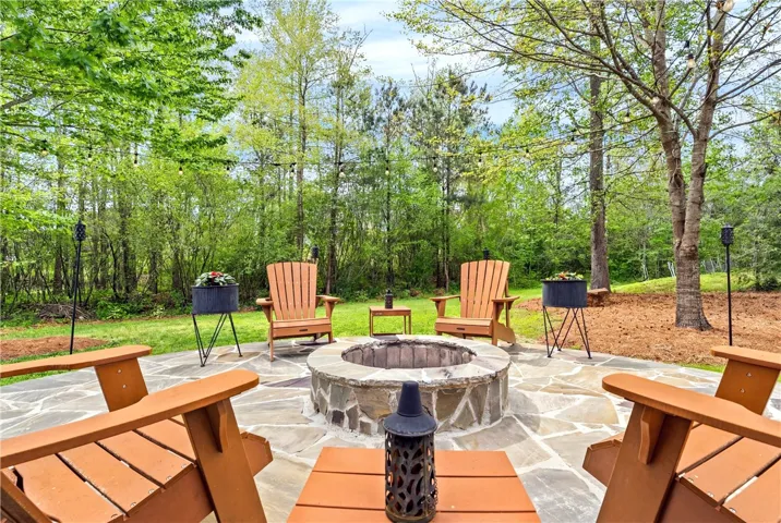 Enjoy tranquil evenings around a rustic fire pit, surrounded by nature's serene beauty.