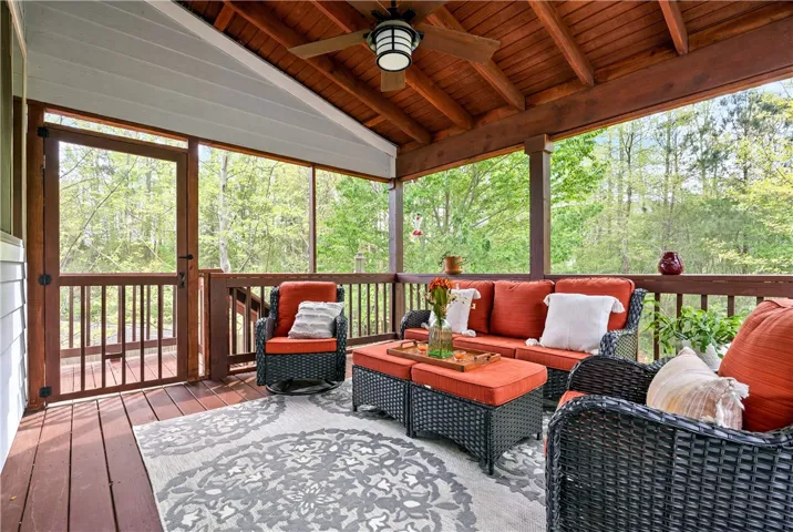 Enjoy outdoor living on this inviting patio, complete with a beautiful wooden ceiling and tranquil views.