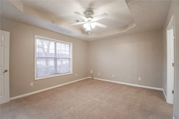 primary bedroom with en suite and walk in closet