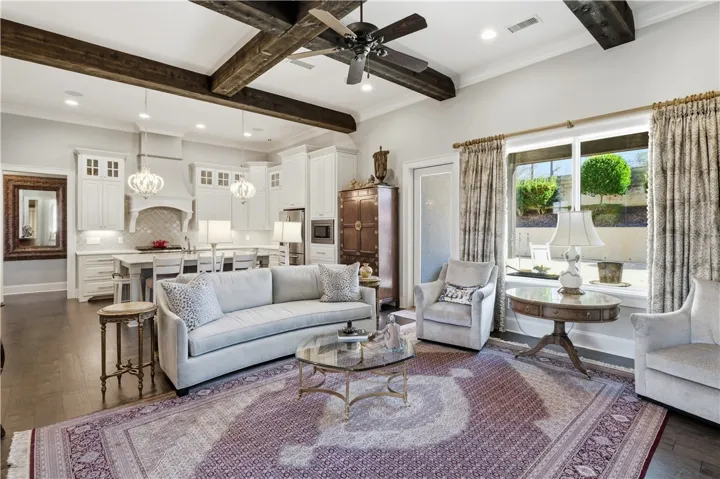Exposed beams define the great room while subtly separating it from the kitchen.