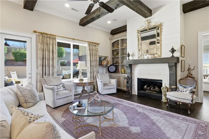 The living room’s large windows capture views of the backyard and pool.