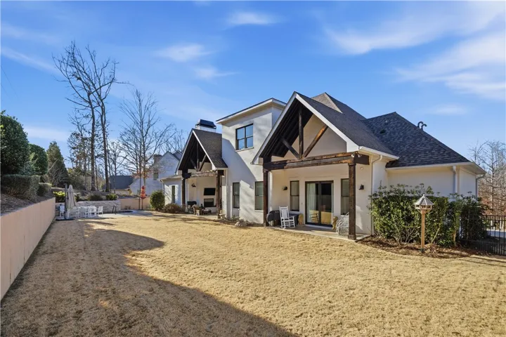 The tremendous backyard is perfectly flat and hemmed in by a wall, fence, and tiered landscaping.