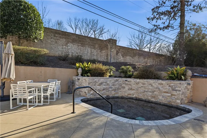 The cocktail pool feels as if it's part of the landscape. Waterfalls cascade from the planters into the pool, their sound lending to the private retreat atmosphere.