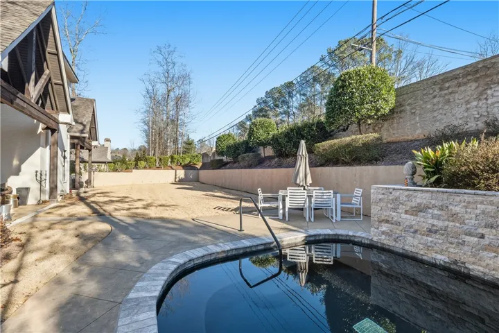 Beyond the pool, the yard offers ample space for a playset, trampoline, or a game of football.