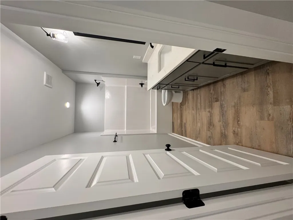 This clean bathroom features sleek fixtures, offering comfort and style.